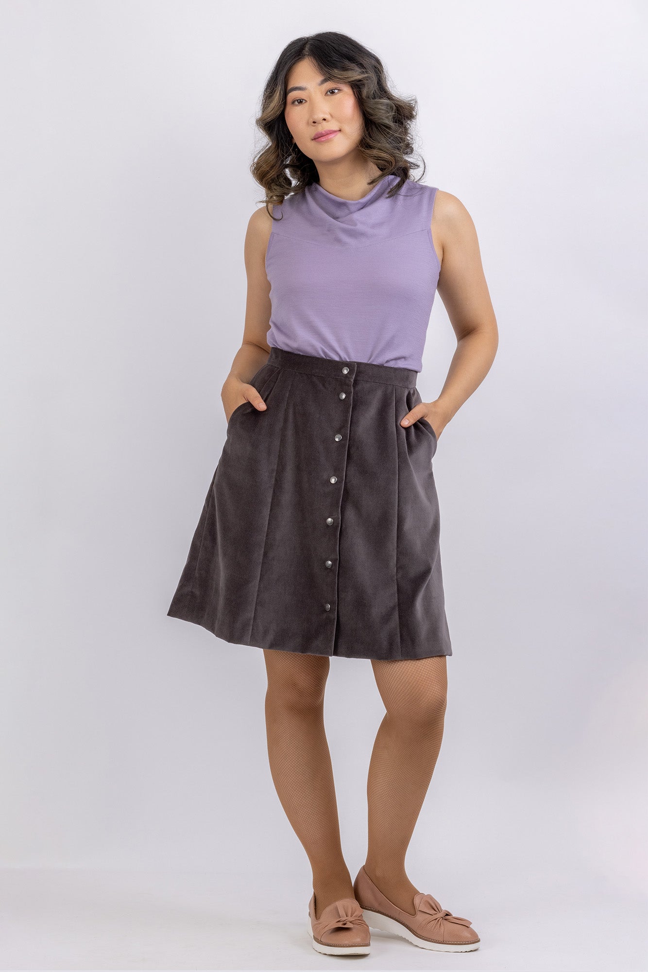 The Natalie skirt, a flared gored skirt pattern with buttons, made in green floral twill, front view.